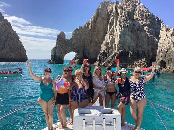 Ladies group celebrating on Lion Heart charter cruise at the Arch of Cabo San Lucas