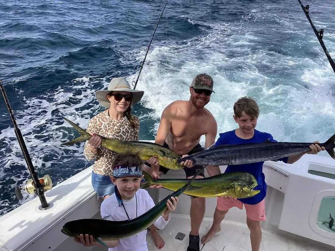 Family with kids and trophy striped marlin on full day fishing charter Lion Heart