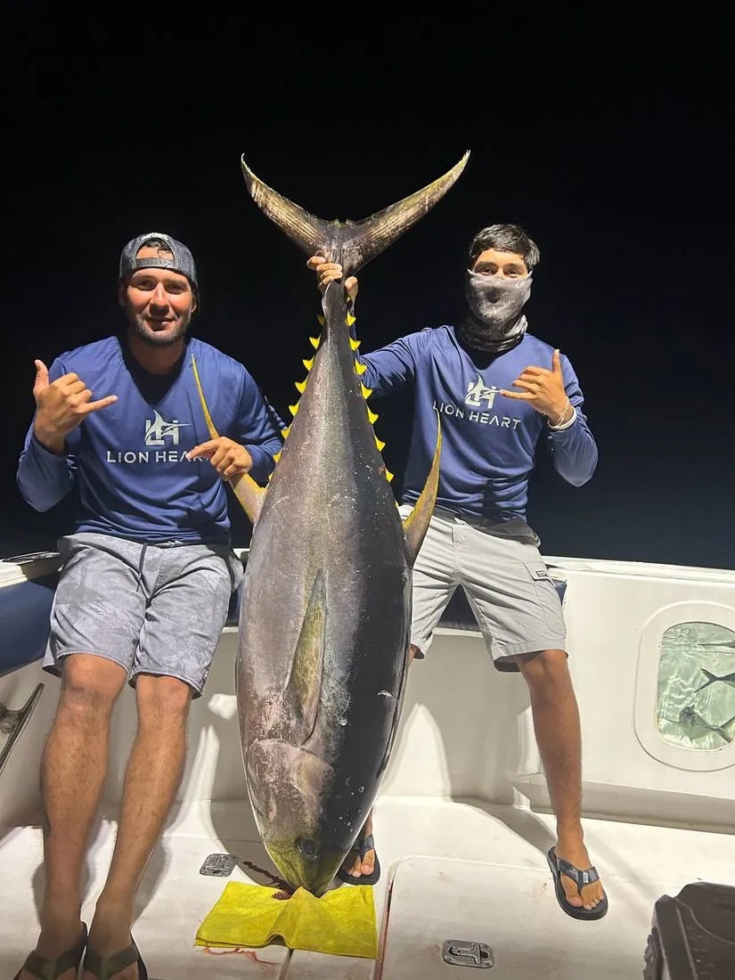 Lion Heart crew with massive yellowfin tuna caught on overnight fishing charter